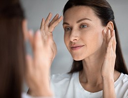 a woman checking her smooth face