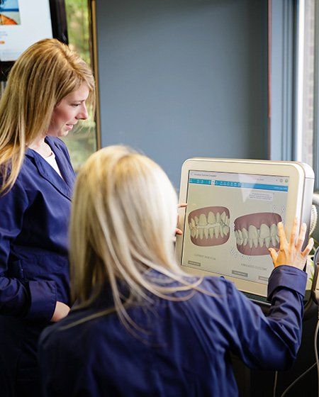 Ann Arbor dental team members looking at digital impressions on computer screen