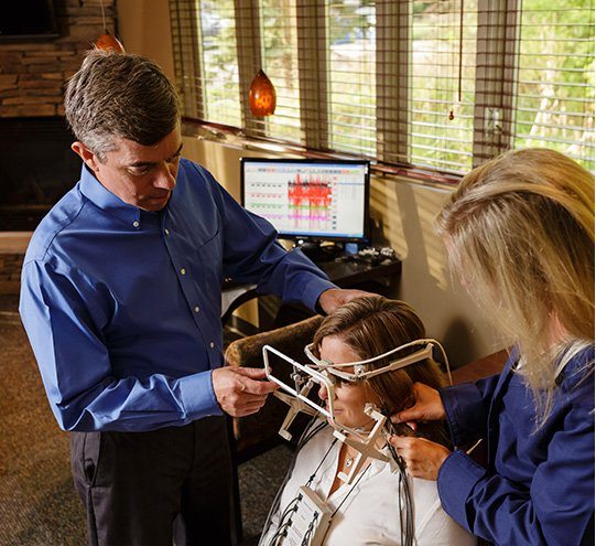 Ann Arbor dentist and team member screening a patient for T M J disorder