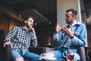 Two men conversing in coffee shop